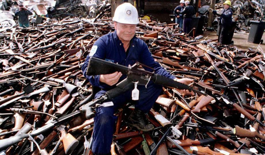 An Australian government worker displays a rifle from the 1996 government buy-back program in this 1996 photograph by William West/AFP/Getty.