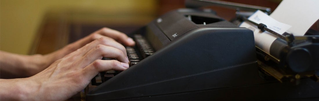 Typing a custom essay on a typewriter