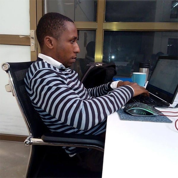 Kenyan writer working on computer