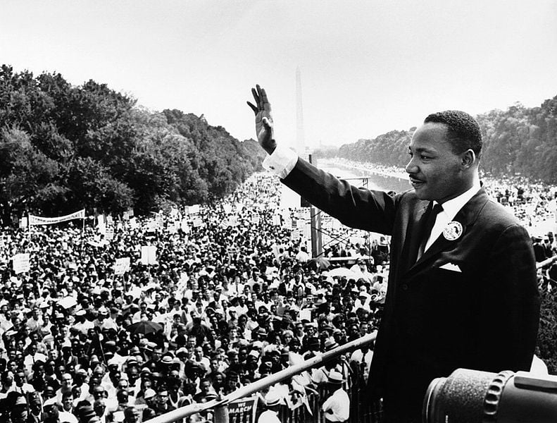 MLK gives his famous “I Have A Dream” speech waving to the crowd.