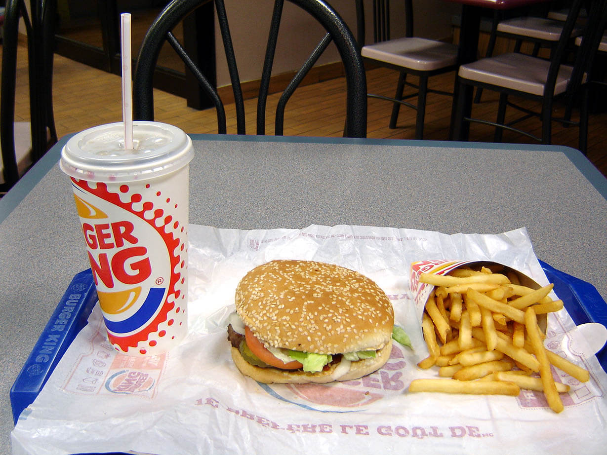 Fast food - French fries, a hamburger, and a drink from Burger King