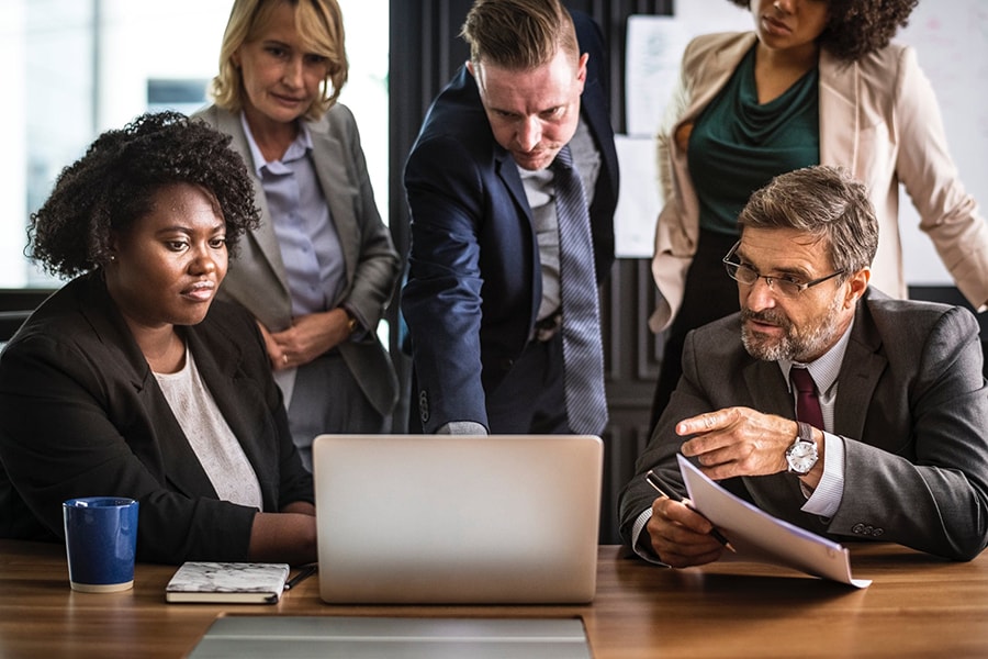 Business associates meeting around a laptop.